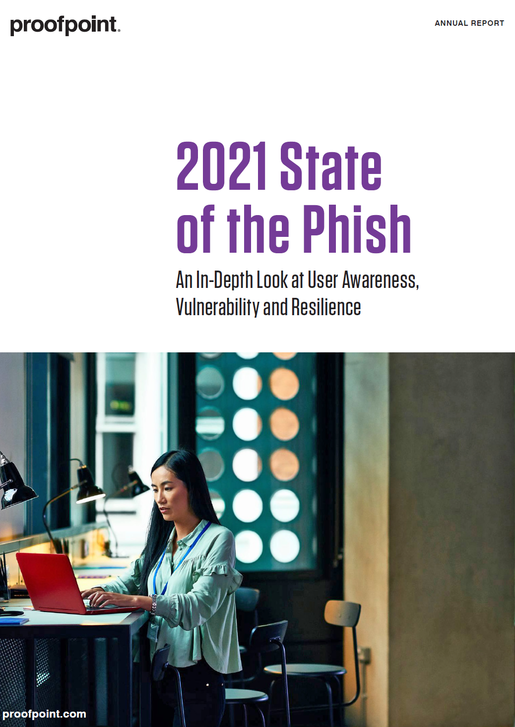 2021 state of the phish - whitepaper from Proofpoint - a woman sits at her computer in an office