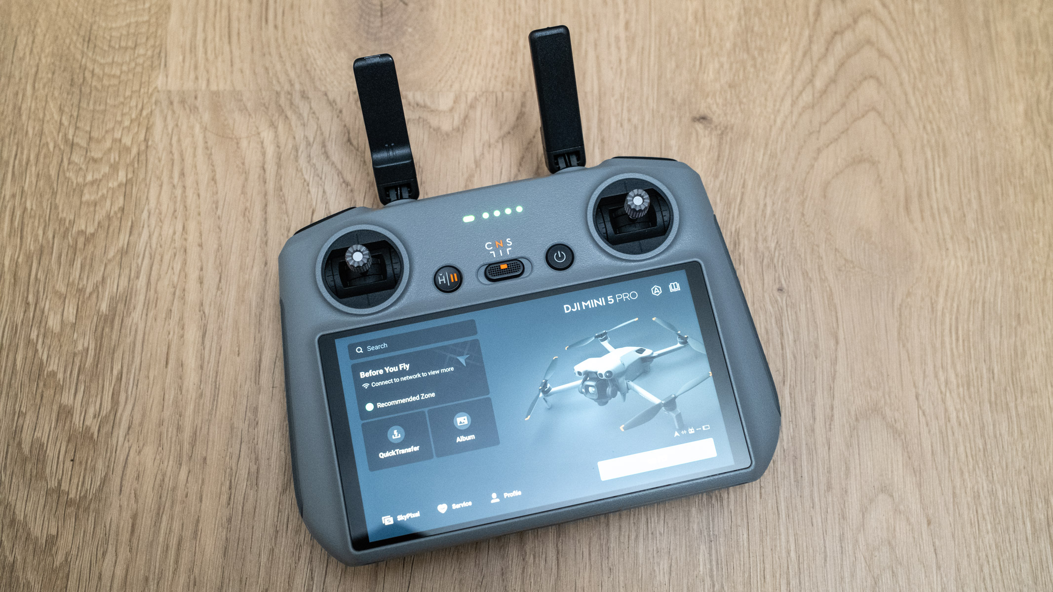 DJI Mini 5 Pro DJI RC 2 smart controller on a wooden floor