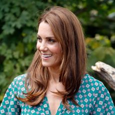 Kate Middleton wears a green patterned dress to visit the RHS Hampton Court Palace Garden Festival to view the Back to Nature Garden which she co-designed at Hampton Court Palace on July 1, 2019