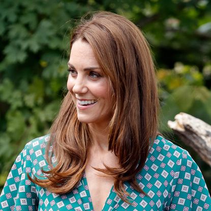 Kate Middleton wears a green patterned dress to visit the RHS Hampton Court Palace Garden Festival to view the Back to Nature Garden which she co-designed at Hampton Court Palace on July 1, 2019