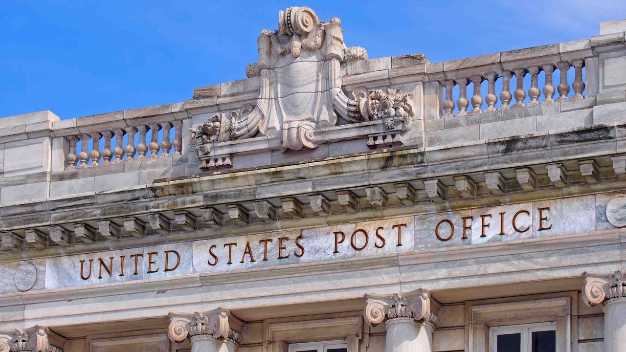 Photo of the words &amp;quot;United States Post Office&amp;quot; engraved in a stone building facade