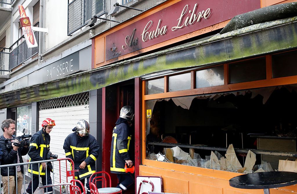 Firefighters enter the burned Cuba Libre bar in Rouen