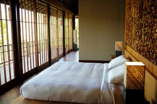 A view of a guest room in the hotel, showing the bed from the side