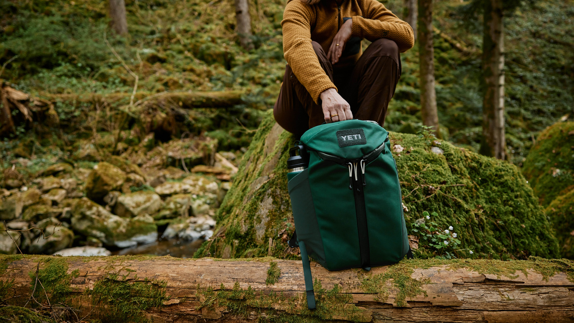 Green YETI Ranchero Backpack in the forest