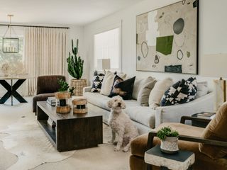 a neutral living room with cowhide rugs