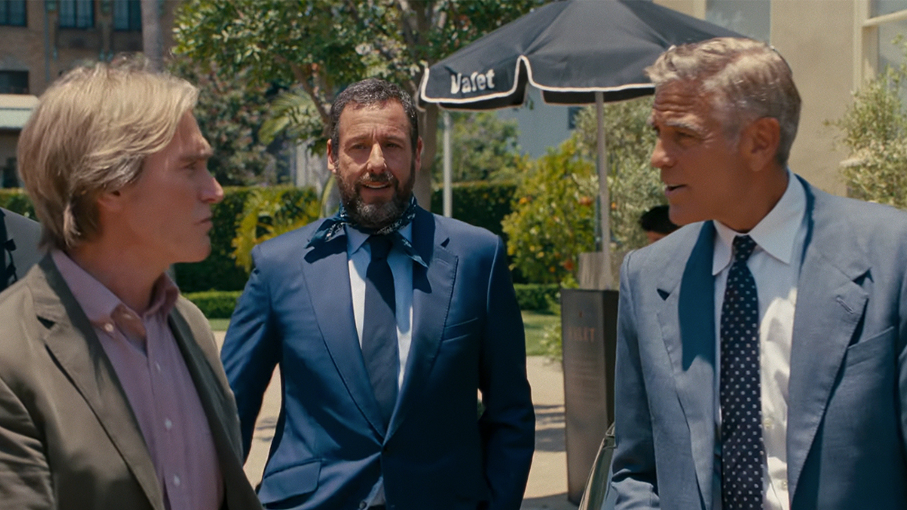 Billy Crudup on the left, talking to George Clooney with Adam Sandler in the middle in Jay Kelly