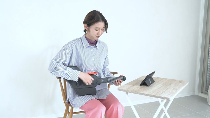 A screenshot from the Guitar Life lesson 1 trailer showing someone playing with the Hori controller on Switch 2