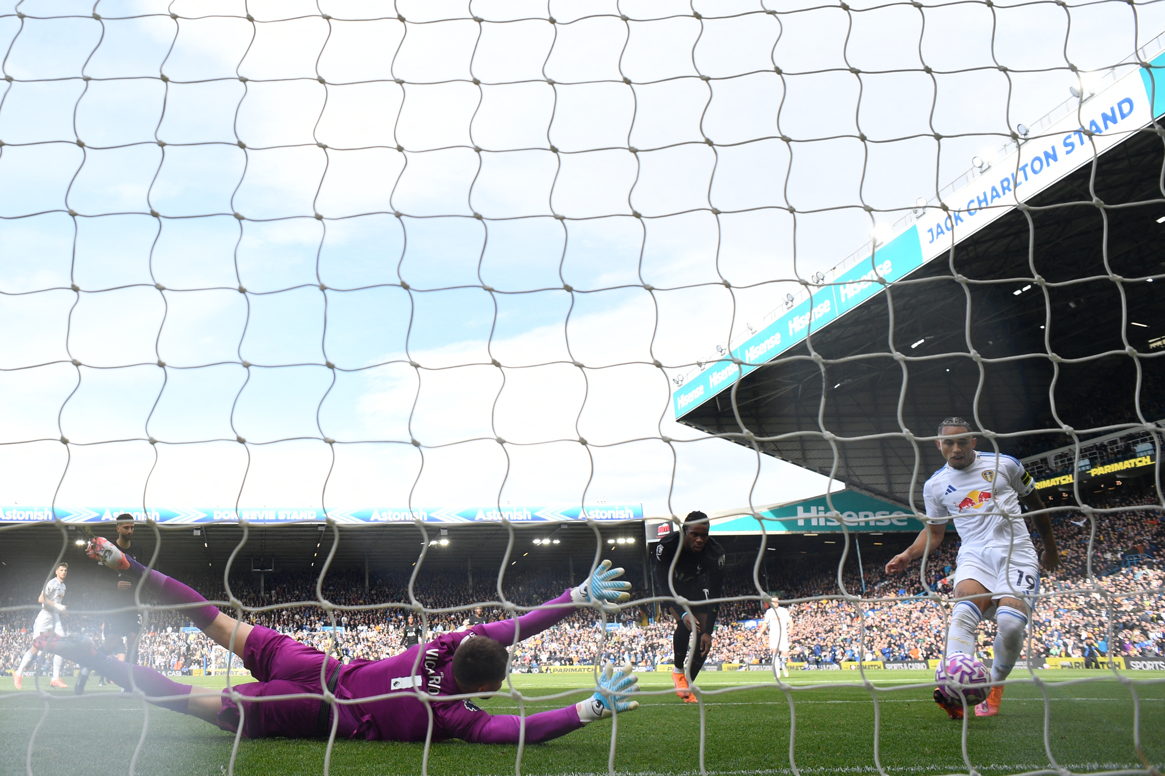 Leeds United&#039;s Swiss striker #19 Noah Okafor (R) scores their first goal past Tottenham Hotspur&#039;s Italian goalkeeper #01 Guglielmo Vicario (L) during the English Premier League football match between Leeds United and Tottenham Hotspur at Elland Road in Leeds, northern England on October 4, 2025. (Photo by Oli SCARFF / AFP) / RESTRICTED TO EDITORIAL USE. No use with unauthorized audio, video, data, fixture lists, club/league logos or &#039;live&#039; services. Online in-match use limited to 120 images. An additional 40 images may be used in extra time. No video emulation. Social media in-match use limited to 120 images. An additional 40 images may be used in extra time. No use in betting publications, games or single club/league/player publications. /