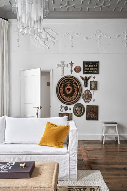 Rustic white living room with white sofa and gallery wall