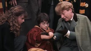 Harry Potter (Daniel Radcliffe), Hermione Granger (Emma Watson), and Professor Lockhart (Kenneth Branagh) in Harry Potter and the Chamber of Secrets