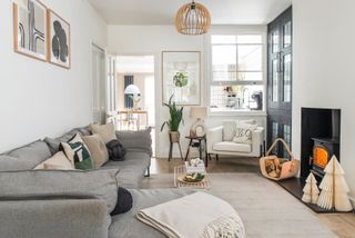 White and beige living room with black built-in cabinetry and framed wall art decor