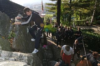 Michael Rogers climbs the wall, with an audience waiting their turns
