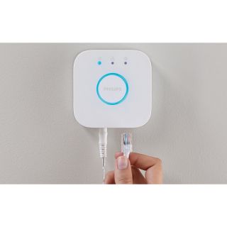 Philips Hue Bridge 2nd generation with cable being plugged in