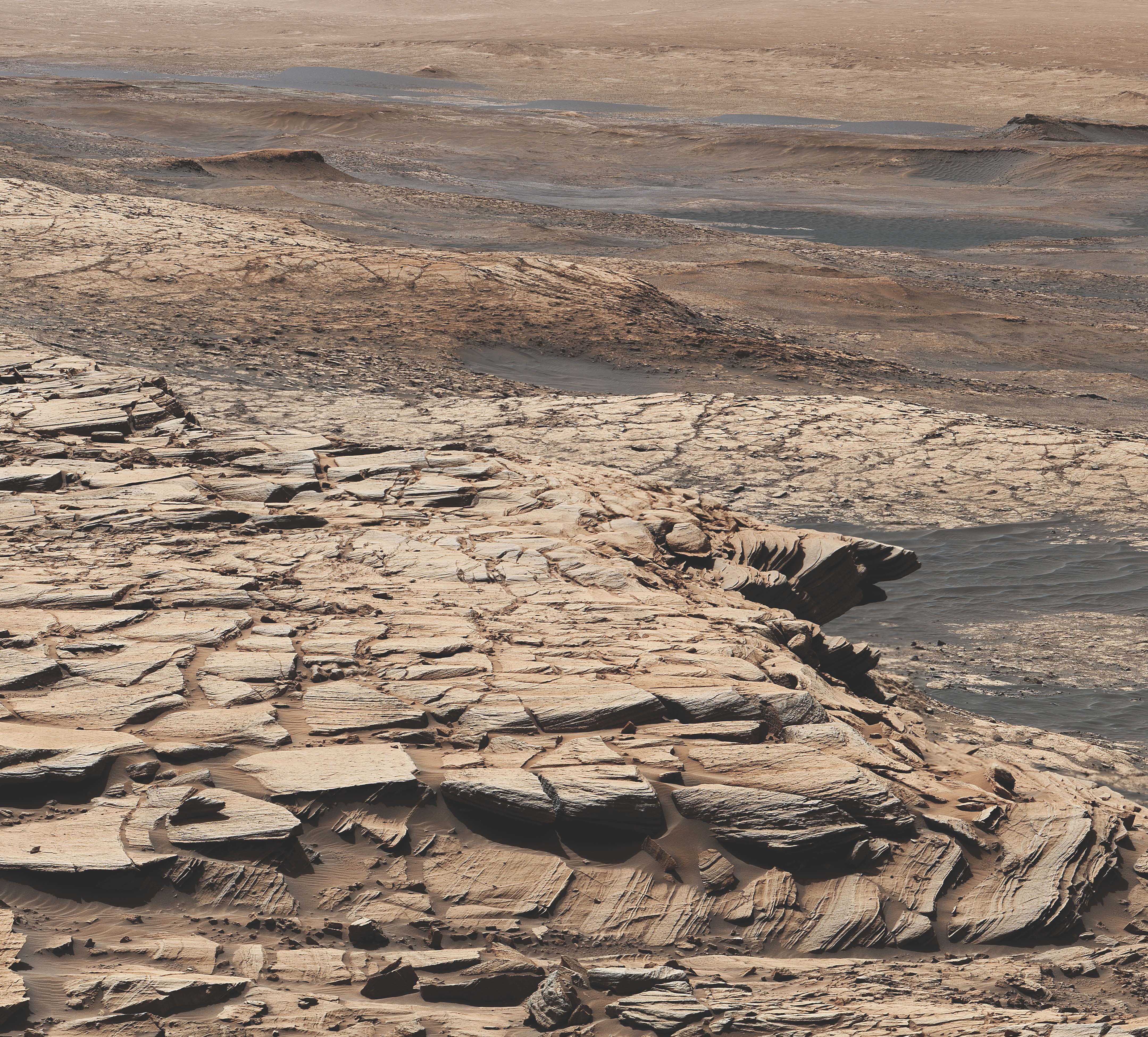 This mosaic was made from images taken by the Mast Camera aboard NASA’s Curiosity rover on the 2,729th Martian day, or sol, of the mission. It shows the landscape of the Stimson sandstone formation in Gale crater. In this general location, Curiosity drilled the Edinburgh drill hole, a sample from which was enriched in carbon 12.