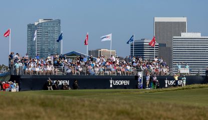 A stand full of people with US Open written on it