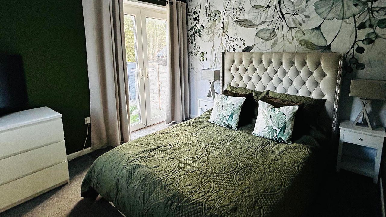 bedroom with green floral wallpaper