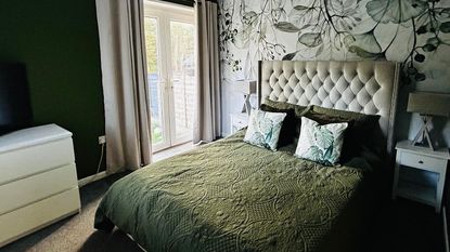 green bedroom with floral wallpaper