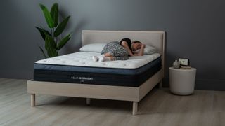 Helix Midnight Luxe mattress with our sleep editor lying on it