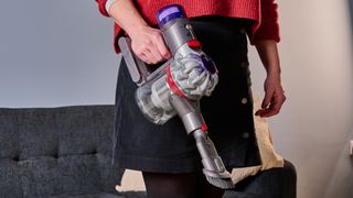 Person holding the Dyson Car+Boat handheld vacuum