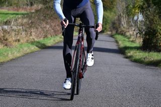 Castelli Espresso Bibtight being worn by a rider standing up out of the saddle