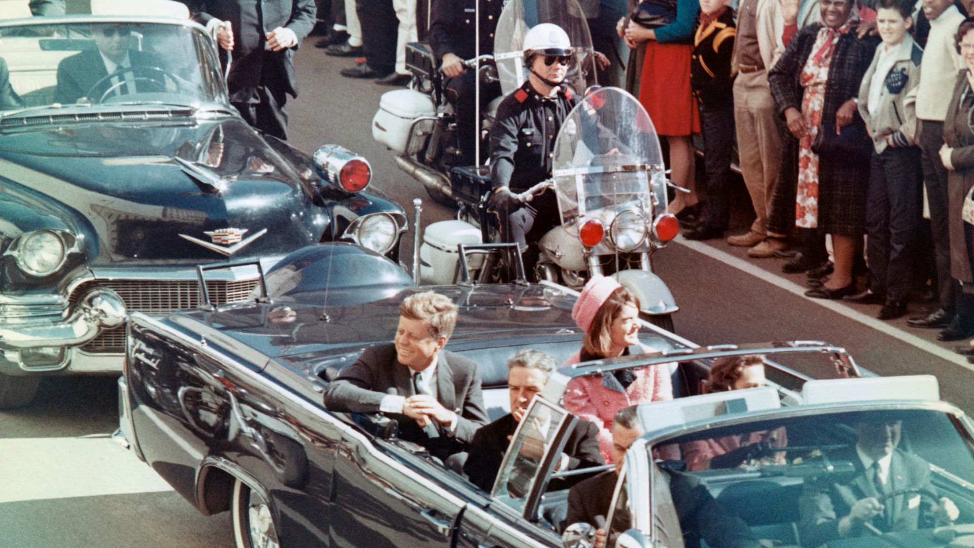 President John F Kennedy and Jackie Kennedy riding in the car before his assassination