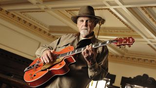 Duane Eddy looking at camera and holding his Gretsch