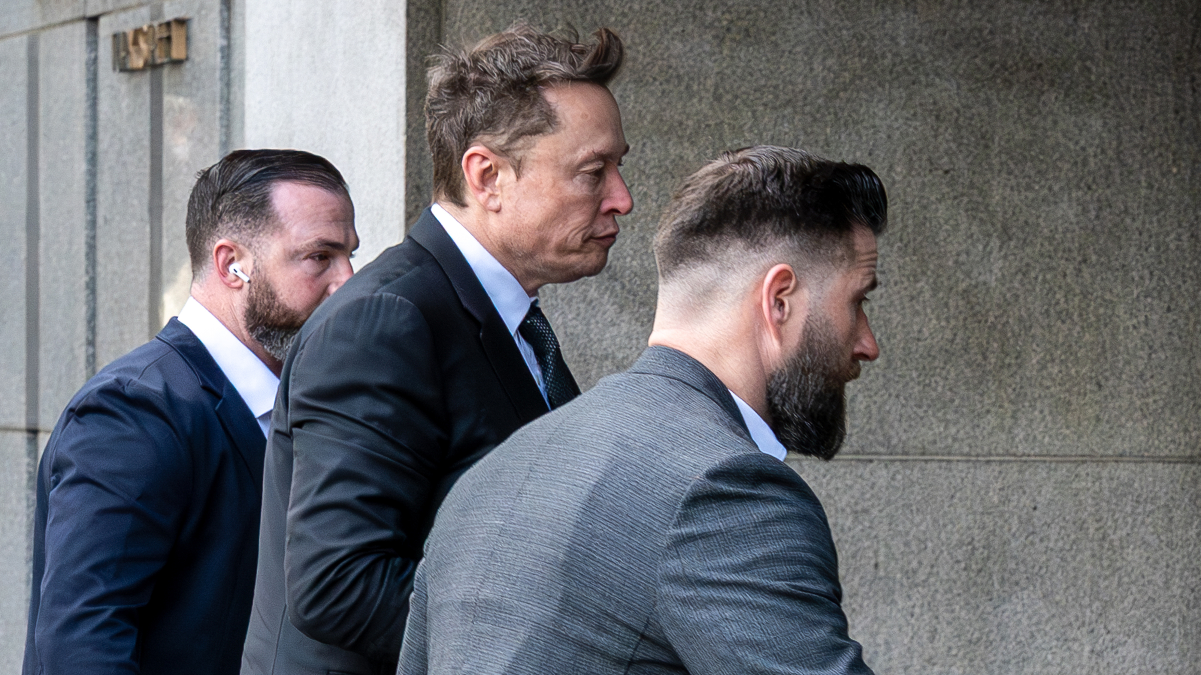 Elon Musk, executive chairman and chief technology officer of X Corp., center, arrives at federal court in San Francisco, California, US, on Wednesday, March 4, 2026. 