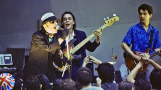 Ian Dury, Norman Watt-Roy and John Turnbull of Ian Dury and The Blockheads perform on stage at the Crystal Palace Bowl on July 29th, 1981 in London, England.