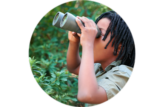 A child looking through binoculars