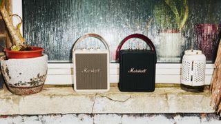Two Marshall Stockwell III speakers, one in cream and one in black and gold