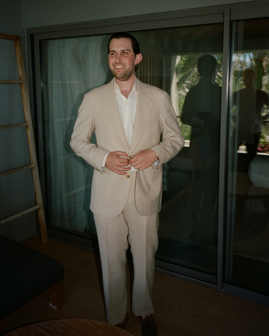 Andrew wears a tan suit.
