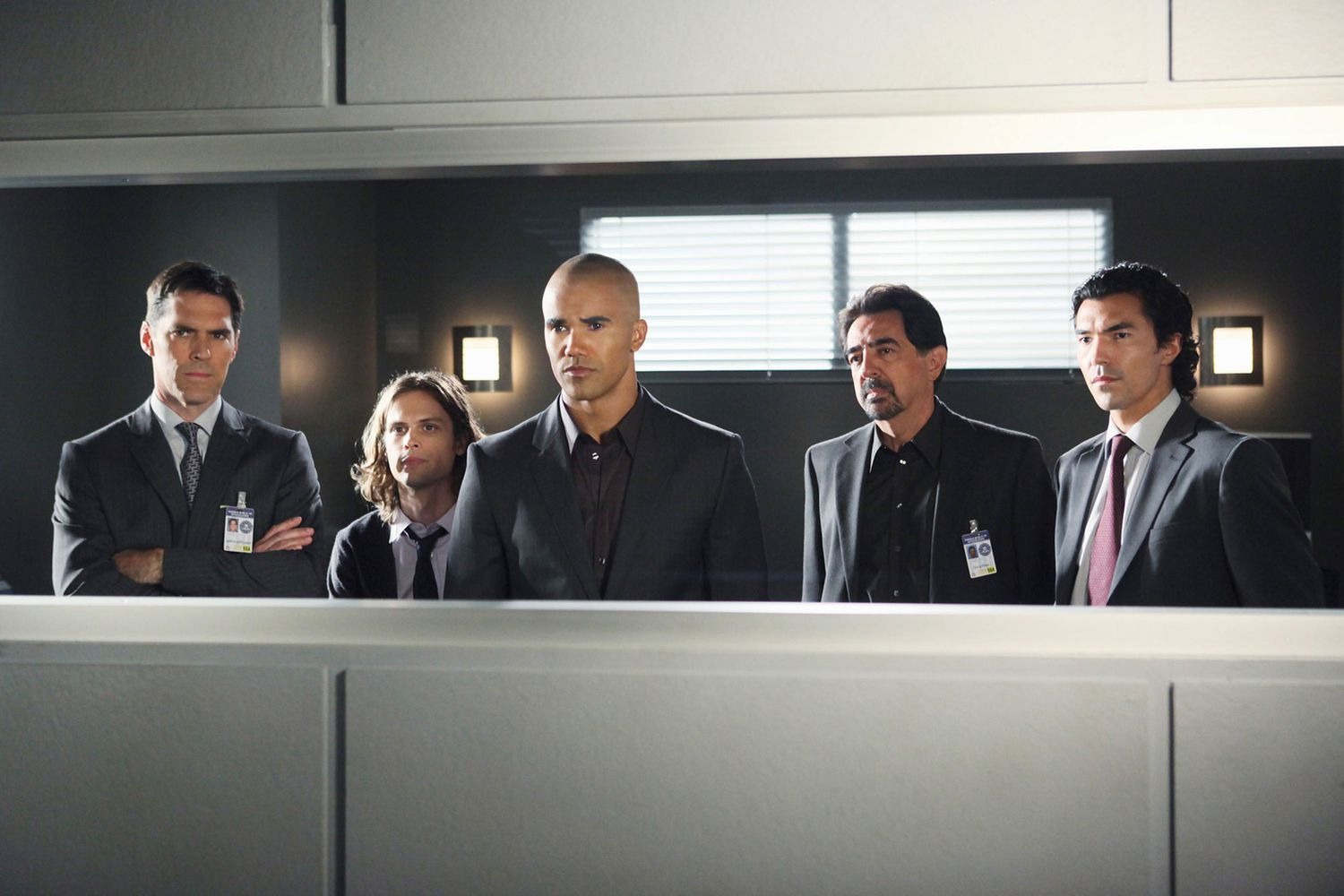 the cast of &#039;Criminal Minds&#039; looks into a two way mirror in a still from the detective series