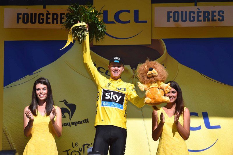 Chris Froome (Team Sky) collects the yellow jersey