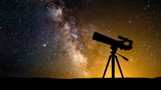 Telescope silhouetted against the milkyway galaxy