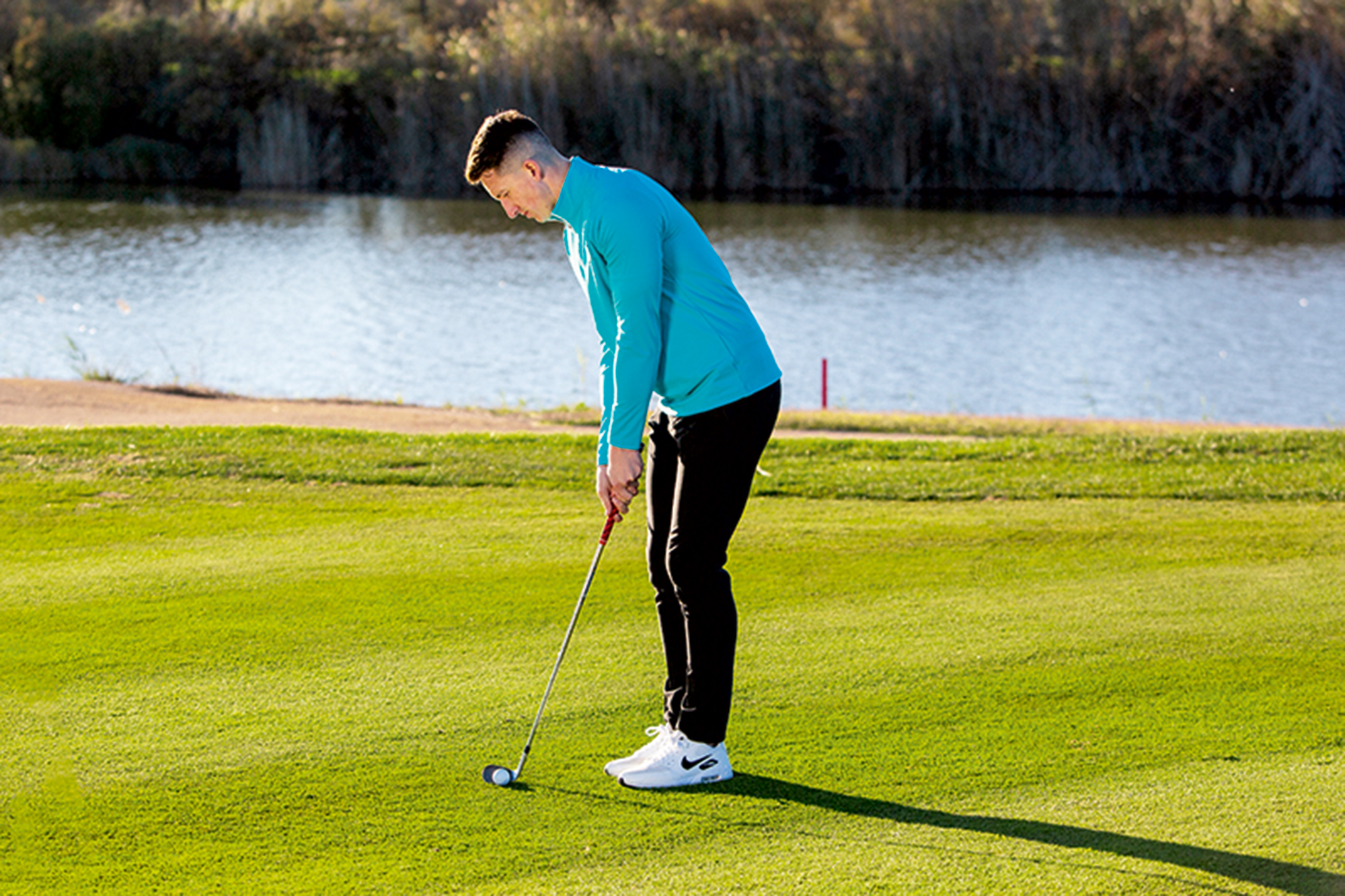 Gary Munro hitting a chip shot from a bare lie just off the green