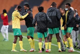 Sipho Mbule celebrates victory with Bongokuhle Hlongwane of Bafana Bafana during the 2022 World Cup Qualifier match between South Africa and Ghana