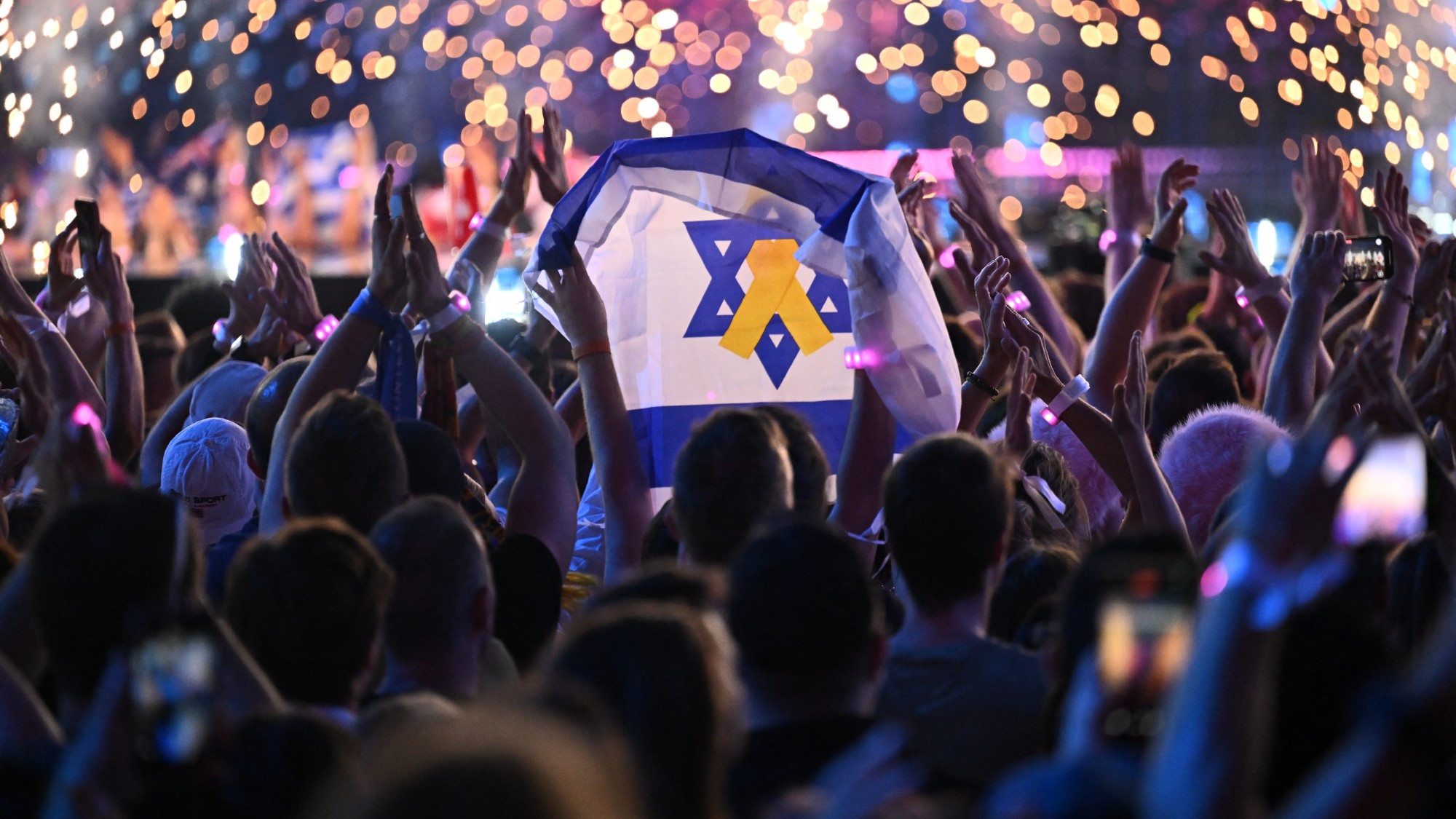 A fan holds up an Israeli flag during the second semi-final of the 2025 Eurovision Song Contest in Basel 