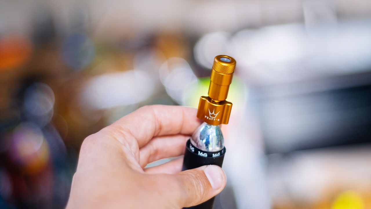 A yellow co2 inflator in a hand