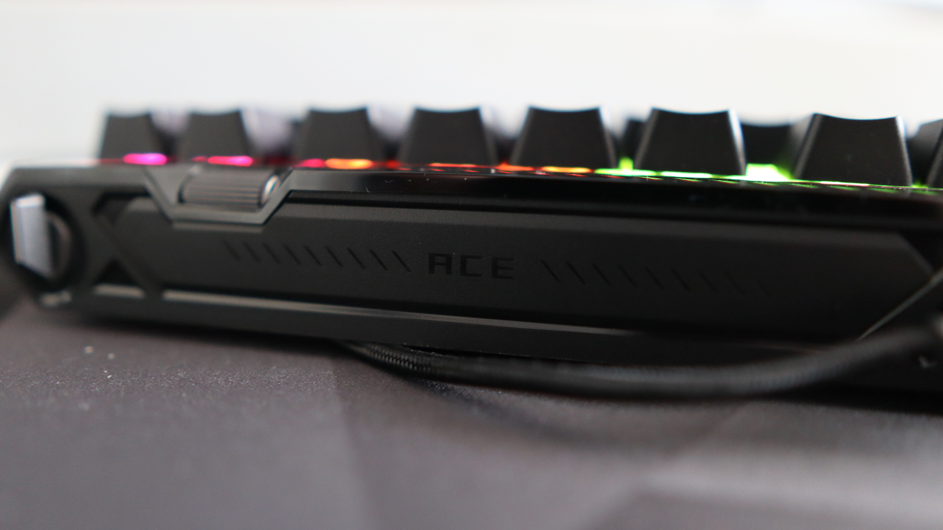 The Asus ROG Falchion Ace 75 HE on a desk with the lighting enabled.