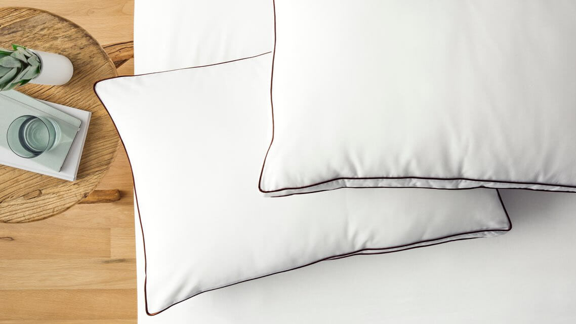 Best pillows: Two Saatva Latex Pillows placed on a white mattress