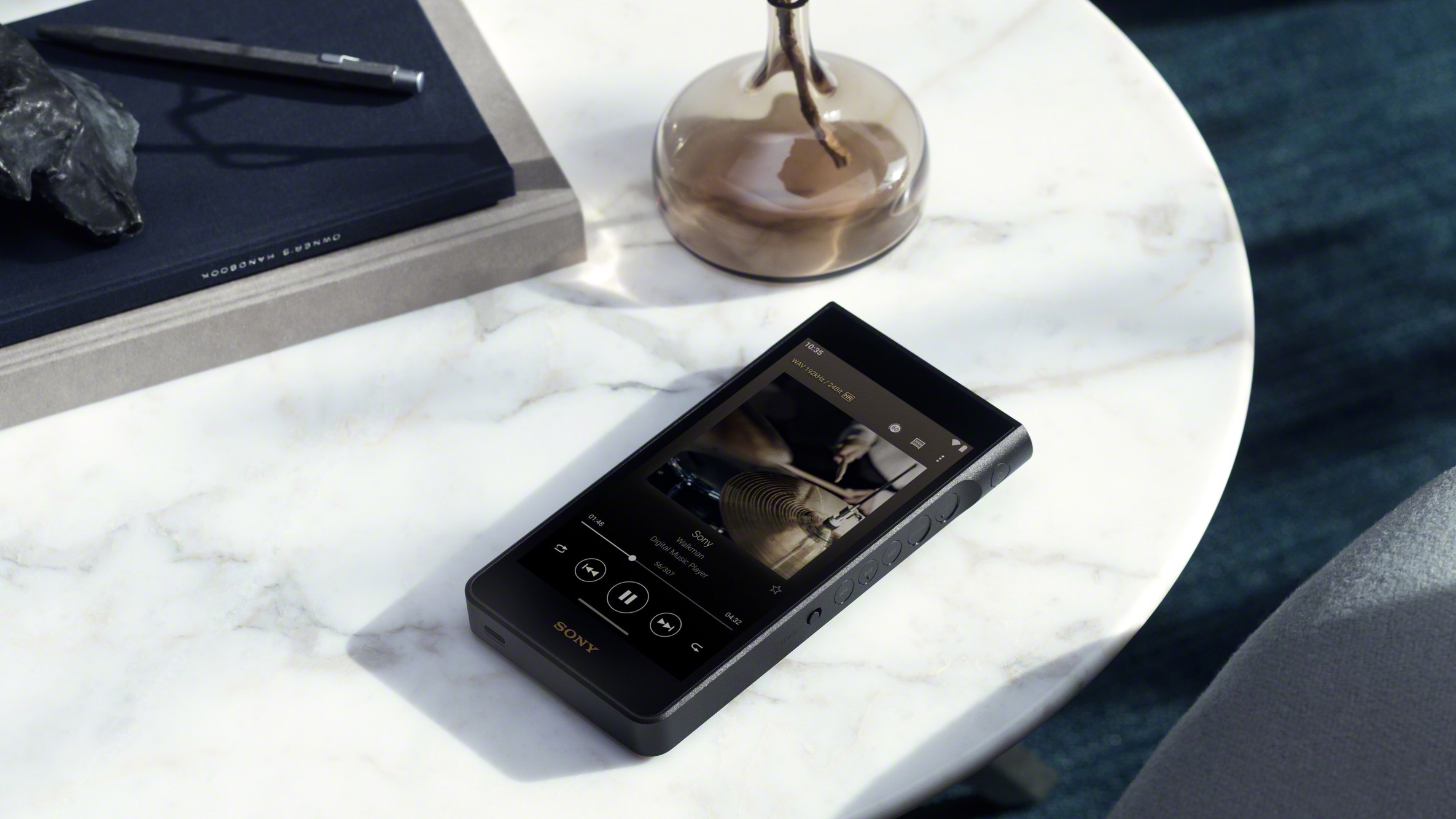 The Sony NW-WM1AM3 Walkman on a marble coffee table.