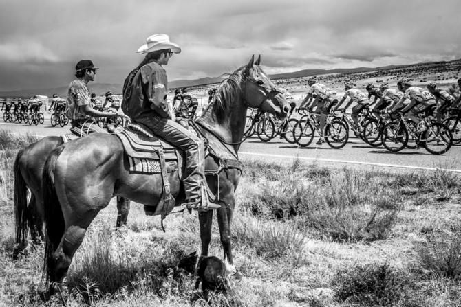 Cowboys stop to watch as the race passes by.