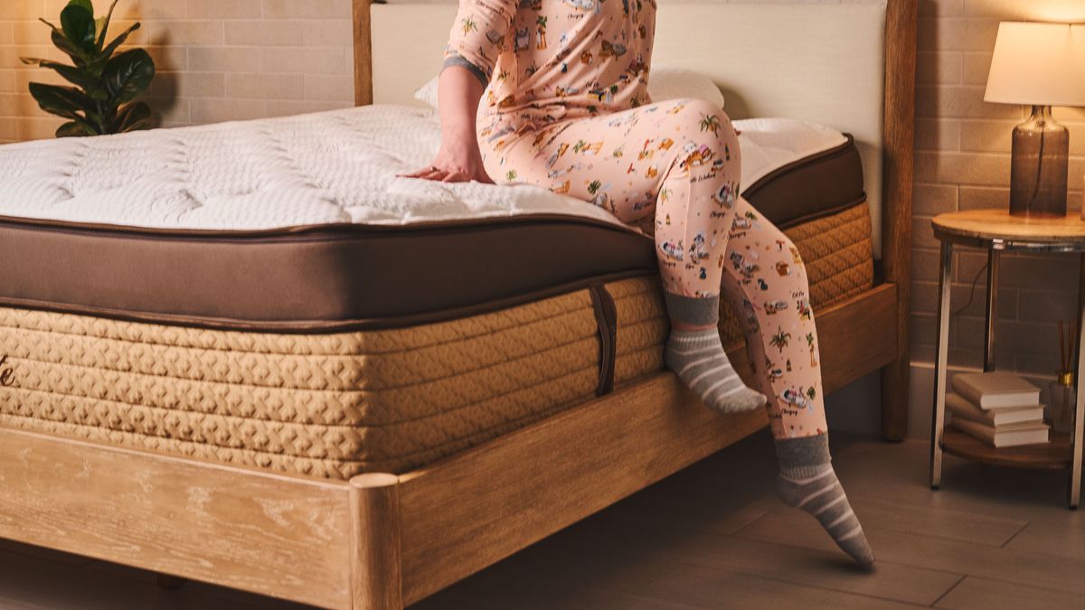 Sleep editor sits on the edge of the Helix midnight elite mattress, which is 16 inches tall. Consider how thick a should mattress be before buying.