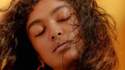  Woman Closing her Eyes with Windswept Hair - stock photo