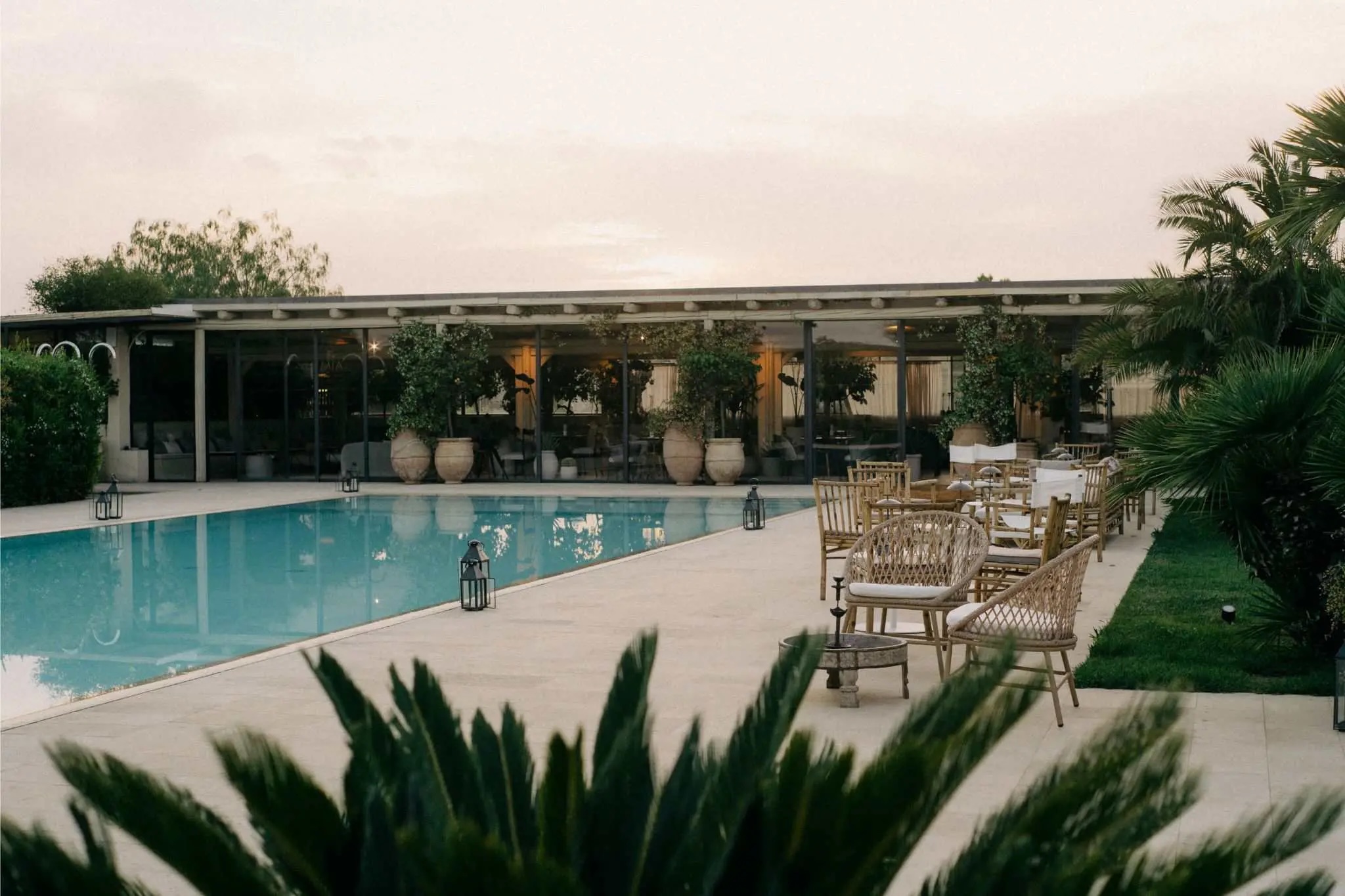Rectangular swimming pool in front of a low slung building