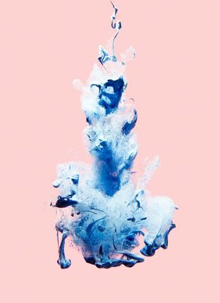 blue powder explosion on a pink background