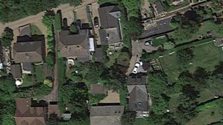 An overhead shot of two house who share connecting gardens
