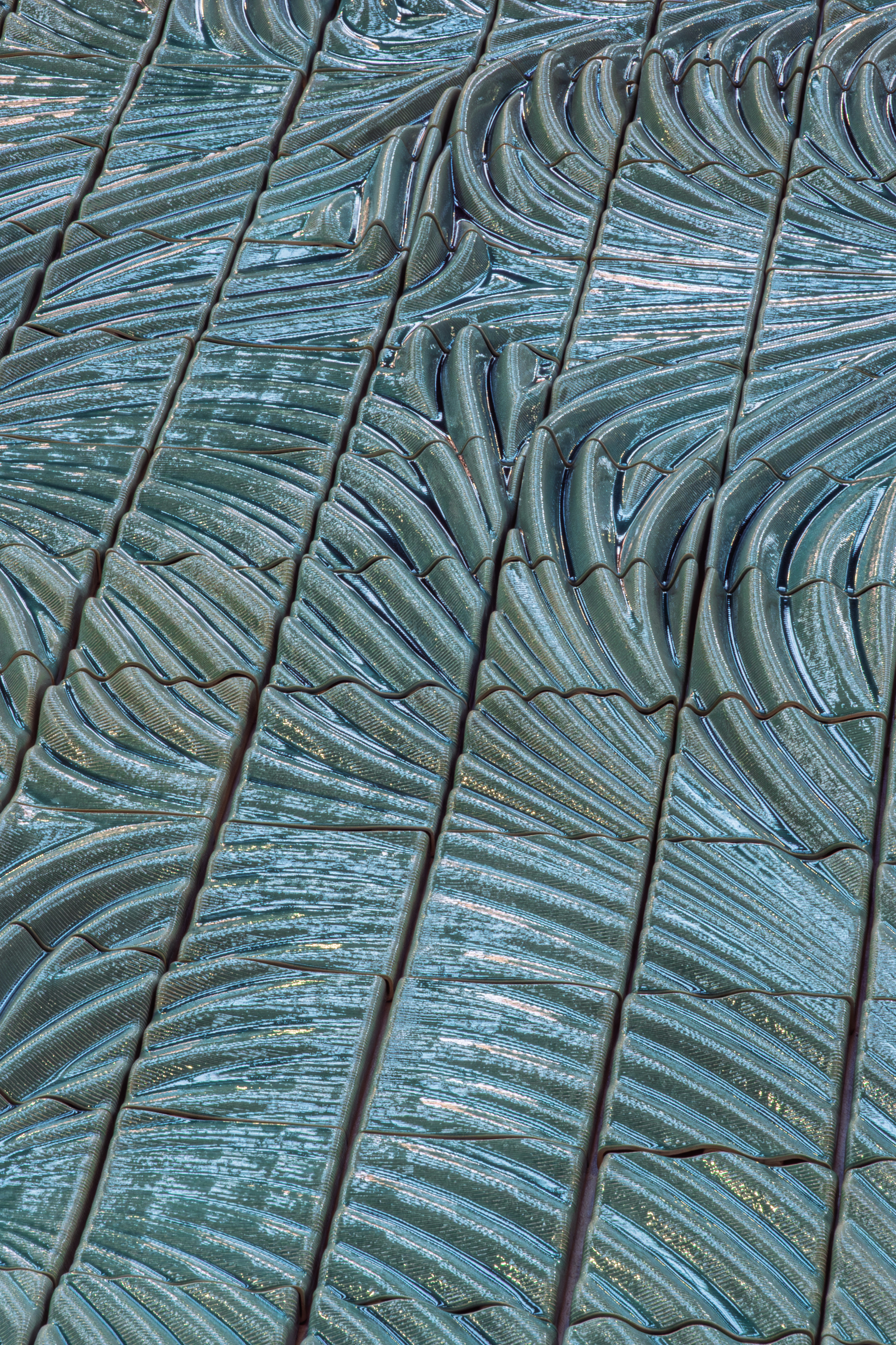 The shape of the forms and density of the glazing creates shifting light across the surface
