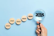 Happy New Year 2025 with a business goals concept. The big black 2025 year number with the Target icon inside the magnifying glass and other years on wooden blocks. Planning for goal and success.