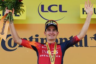 INEOS - Grenadiers' Spanish rider Carlos Rodriguez Cano celebrates on the podium after winning the 14th stage of the 110th edition of the Tour de France cycling race, 152 km between Annemasse and Morzine Les Portes du Soleil, in the French Alps, on July 15, 2023. (Photo by Thomas SAMSON / AFP)
